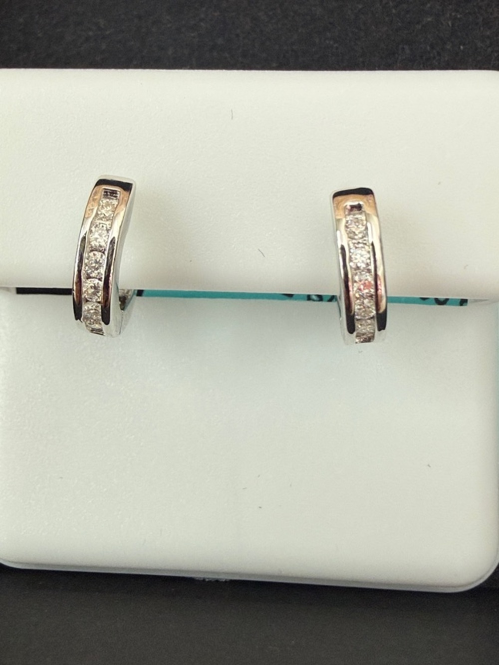 Sterling silver and Moissanite huggie earrings.